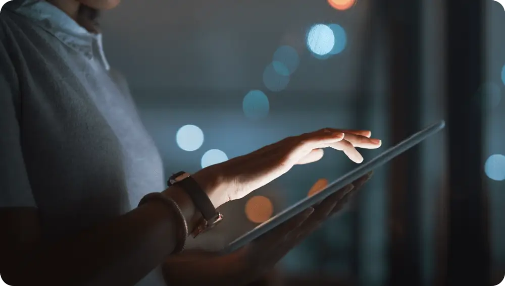 A person using a tablet in a server room